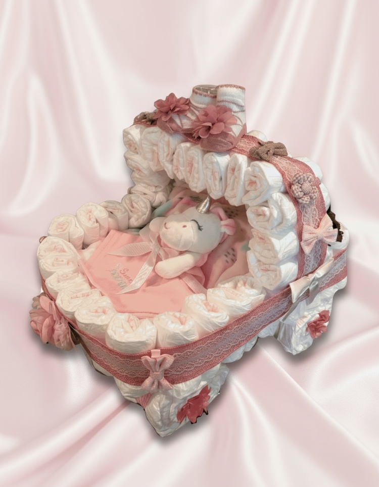 Diaper cake shaped like a baby carriage with flowers, blanket, stuffed animal and other hair accessories.
