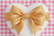 gold satin bow on white heart with pink gingham animated back drop